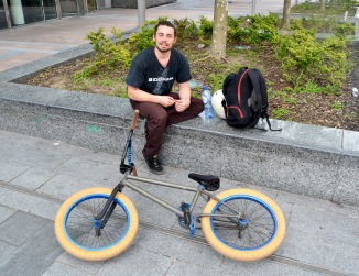 ©Barry Sandland/TIMB - BMX rider w his bike resting at the EU Parliament esplanade