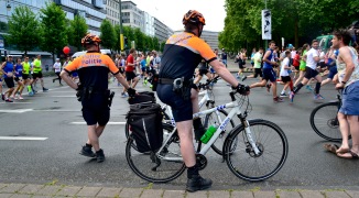 Barry Sandland/TIMB - Two bicycle police officers watching the Brussels 20km run