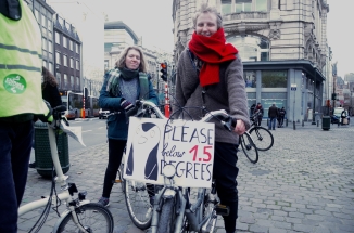 ©Barry Sandland/TIMB - Cyclists with a poster reading Please Below 1.5 degrees on the Climate Change protest ride