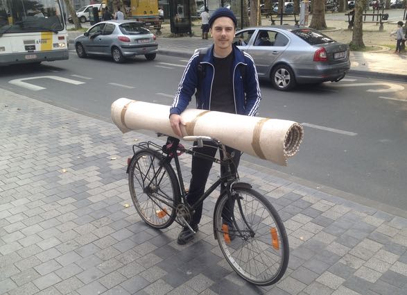 ©Barry Sandland/.TIMB - City cyclist using his bike to transport a carpet